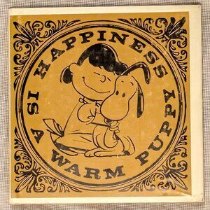 HAPPINESS IS A WARM PUPPY, BY CHARLES SHULTZ,1962